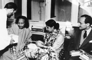 Swami Kriyananda presents Yogananda and Mme. Sen with a box of singharas (exact date unknown)